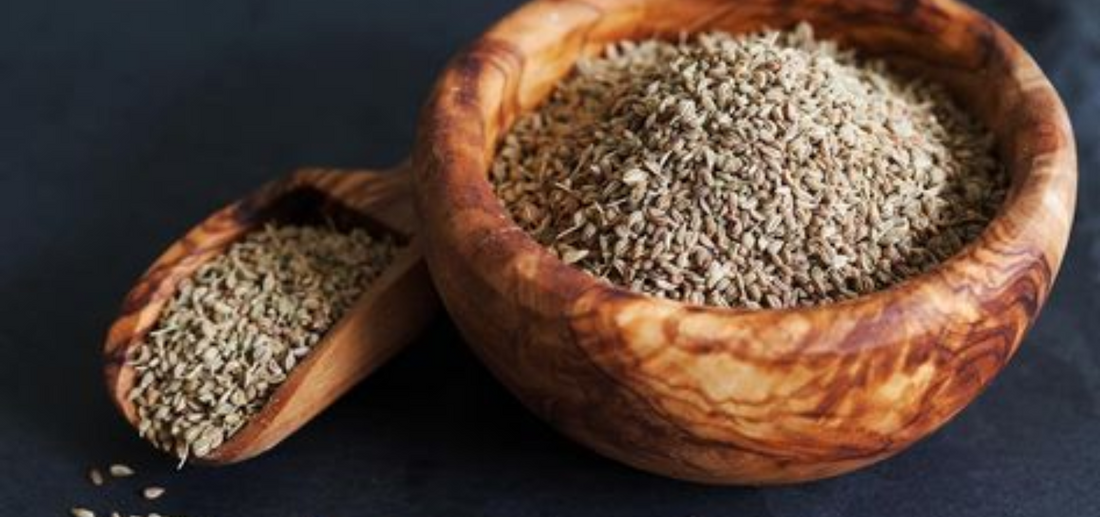 carom seeds on wooden bowl and spoon